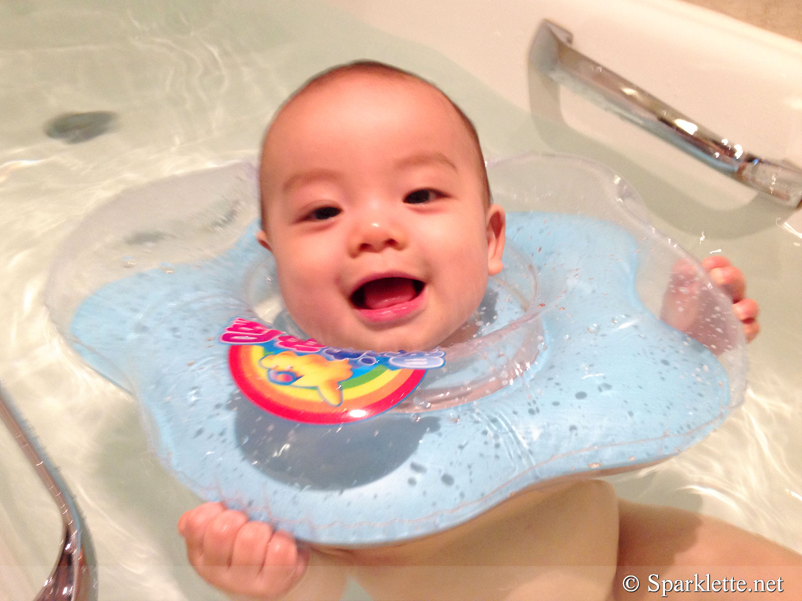 Baby swimming in bathtub